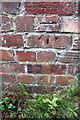 Benchmark on wall beside path to Pinnocks Way