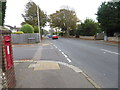 Child being taught to flout the law and ride a pedal cycle on the pavement