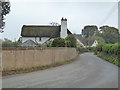 Houses by the road at the northern end of Poltimore village