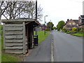 Wooden bus shelter along Old School Lane