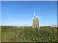 The hedge topping Lane End Field Triangulation Pillar sprouting a Wind Turbine