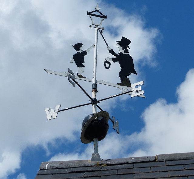 Weather vane on top of a barn