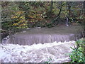 The Black Brook in spate at a weir, Greetland