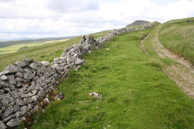 Ruined dry stone wall beside Long Lane at Dub Cote Scar Pasture