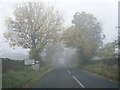 A686 at a misty Melmerby village boundary