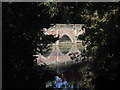 Ornamental bridge across lake at Capesthorne Hall near Siddington