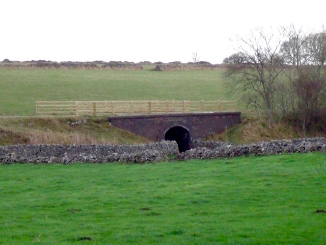 Former railway bridge over a footpath and farm access