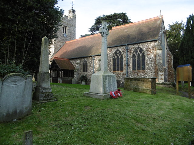 The war memorial and the Church of St Peter and St Paul, Harlington