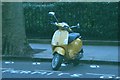 View of an unusual yellow Vespa on Cadogan Gardens