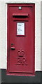 Queen Elizabeth II postbox in the wall of the former village post office, Pucklechurch