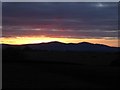 SO8848 : Sunset behind the Malvern Hills by Philip Halling
