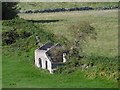 NT9827 : Ruin by Green Castle by Richard Webb