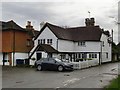 Weather-boarded cottage at the corner of Wykehurst Lane