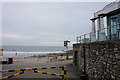 Multiple signs on the seafront at Langland Bay