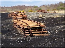 N1621 : Rails stacked beside the peatland light railway by Oliver Dixon