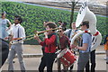 View of Datbrass brass band parading along King