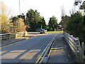 Burmarsh Road joining Hythe Road (A259) over a bridge that spans Hoornes Sewer