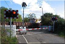 SK8316 : Whissendine Station level crossing, signal box, train and a digger by Andrew Tatlow
