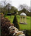 Pillared and domed structure over a bench in a Broadway garden