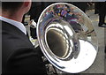 Spectators on Flora Day 2016 reflected in a euphonium