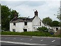 SJ8154 : Burnt-out shell of Toll Gate Farm on A5011 by Jonathan Hutchins