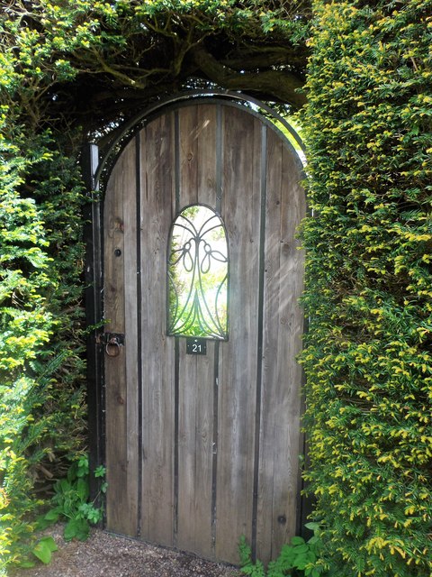 Gate through topiary in Kellie walled garden