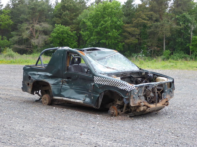 Wrecked car on former paintball site