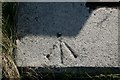 Rivet in concrete drain surround near  Aird Mhidhinis, Barra