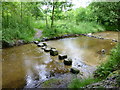 Stepping stones cross a feeder channel for Arnfield Reservoir