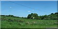 Hay field sloping down to the River Callan from the direction of the Keady Road