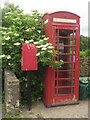 NY0634 : Telephone box, Harker Marsh by Graham Robson