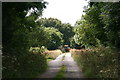 Distant harvester in Sleights Lane, off New Carr Lane, Eastrington