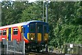 View of a Class 455 train approaching Strawberry Hill station