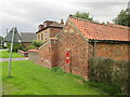 Brick  outbuilding  at  Sandholme  with  Victorian  letterbox