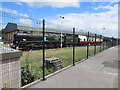 Steam locomotive 34052 Lord Dowding behind a Gloucester station fence