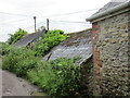 Roofs disappearing beneath vegetation