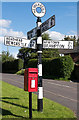 NY4767 : Signpost and postbox, Hethersgill - August 2016 by The Carlisle Kid