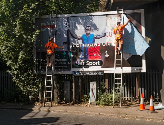 Billboard poster change-over, Bunns Lane, Mill Hill
