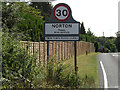 TL9567 : Norton Village Name sign by Geographer