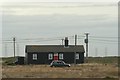 View of a large cottage in Dungeness from the beach