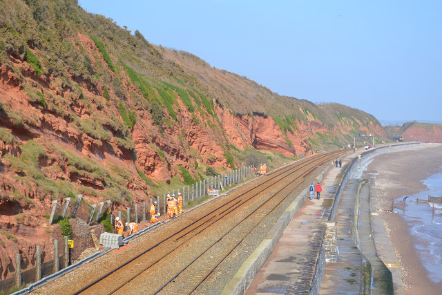 Contractors erecting fencing by the railway north of Dawlish, to catch falling rocks