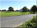 Open land with play area and seating by Elm Grove