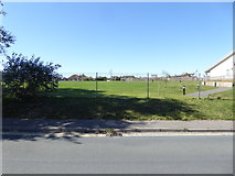 TQ1904 : Looking across Old Salts Farm Road into school playing field by Shazz