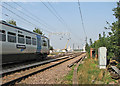 Northbound train passing Fen Road Level Crossing