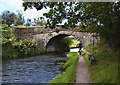 A cyclist approaches Bridge 110 on the Leeds and Liverpool Canal