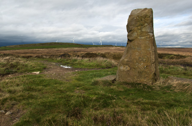 Standing Stone with a wind farm in view