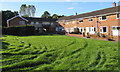 Tyre tracks on the grass in front of Pant-yr-Eos houses, Pontnewydd, Cwmbran