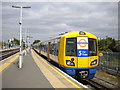 Overground train leaving New Cross