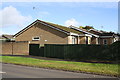 Houses of Edgeworth Drive behind wall and fence of Upavon Way