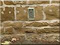 Flush bracket bench mark, Main Road, Wycomb